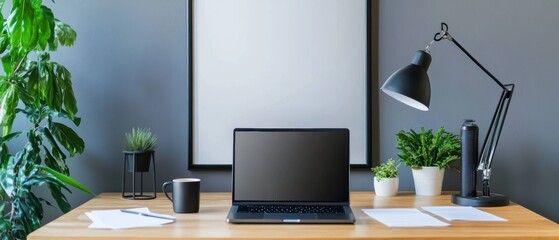 Modern workspace with a chic desk, laptop, and desk lamp, featuring a customizable poster mockup, greenery, and stylish office accessories. Perfect for interior design.