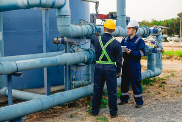 Plumbing engineers are hard at work inspecting the operation of a water system in an industrial...