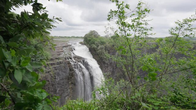 The Victory Falls natural wonder of the world from the Zimbabwean viewpoint with greenery in the foreground during the rainy season