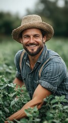 Happy farmer smiling and taking care of his crops in the field