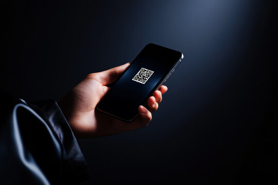 Mobile device displays a QR code in a dark setting, emphasizing technology and modern communication