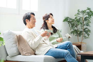 リビングでティータイムする50代夫婦