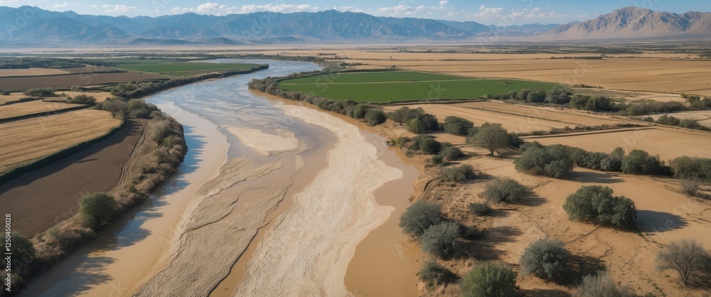 Poster aerial view of dry river landscape with fields and mountains in background ideal for nature and trav