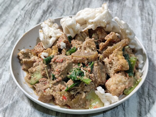 Rujak Cingur. Traditional Javanese food consisting of lontong with vegetables, peanut sauce, petis, tempeh, tofu, beef tongue, and crackers.