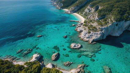 Aerial Coastal View Showcasing Clear Blue and Emerald Waters with Rocky Shoreline and Lush Greenery in Bright Natural Lighting