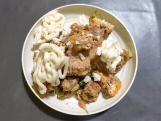 Rujak Cingur. Traditional Javanese food consisting of lontong with vegetables, peanut sauce, petis, tempeh, tofu, beef tongue, and crackers.