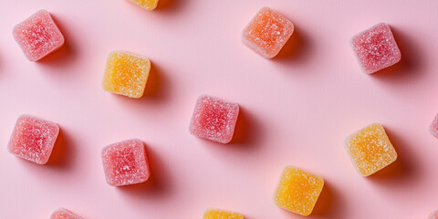 Colorful handmade fruit gummies scattered on pink background, evoking joy