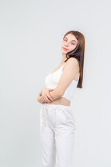 Young cute brunette girl standing on a white background. Copyspace