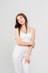 Young cute brunette girl standing on a white background. Copyspace