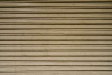 Textured Metal Roller Shutter Door in Neutral Beige.