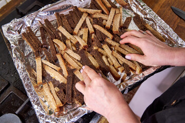 on the tray lay slices of gray and black bread for breadcrumbs