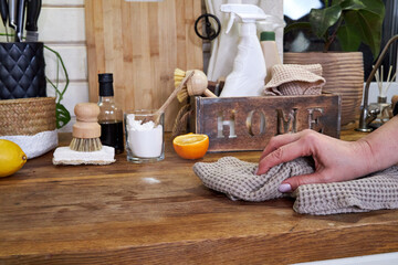 a woman washes white kitchen doors in a house