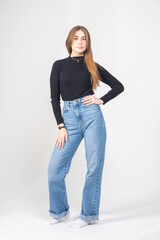 Cute young brunette standing on a white background