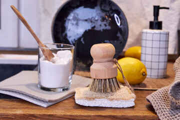 natural detergents and wooden dishwashing brushes in the kitchen