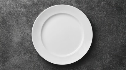 Top view of an empty white plate on dark textured surface symbolizing food deprivation and hunger