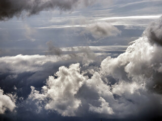Cloudy pre-storm sky. Dark and white clouds on a background of blue sky