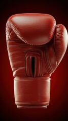 Red boxing glove on dark background for sports and fitness concepts