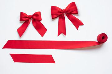 Closeup images luxurious tied red satin ribbon bow with fabric delicate texture for decoration gift card design in celebrations or special holiday themes.realistic elements.not ai generated.