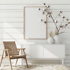 A white cabinet with a wooden framed picture. a chair. and a vase of cotton plants
