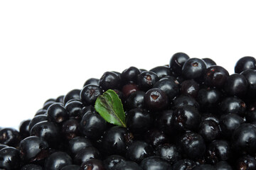 A heap of fresh aronia berries decorated with a green leaf, white background