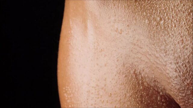 Beautiful body of naked woman with water droplets
