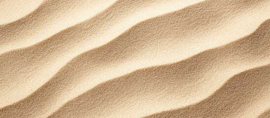 Sandy soil texture with wavy patterns showcasing natural surface undulations and fine grains in a warm beige hue.
