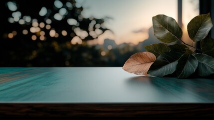 Glittering Leaves on Dark Teal Table Against Sunset Cityscape