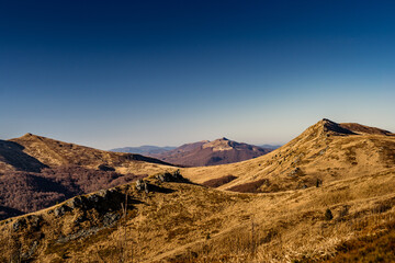 Scenic autumn landscapes from a trekking loop in Bieszczady, featuring views from Tarnica, Halicz, Rozsypaniec, Bukowe Berdo, Połonina Wetlińska, and the Ukrainian Bieszczady under a clear blue sky