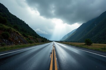 Fototapeta premium A Scenic Highway Cutting Through Lush Mountain Valley Under a Dramatic Cloudy Sky