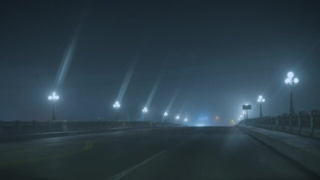 Foggy night driving across a bridge 