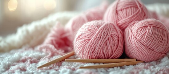 Knitting essentials featuring a soft pink yarn, wooden needles, and an unfinished project on a light background for cozy crafting vibes.