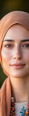 Fototapeta premium Contemporary Ramadan Elegance Radiant Woman in Hijab with Prayer Beads in Golden Light - Ethereal Portraits for Cultural Publications and Lifestyle Branding