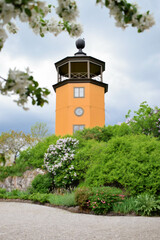yellow wooden tower surrounded by blooming spring garden in Sweden