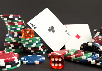 Obraz premium red dice, cards and poker chips, on a black background 
