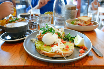 Cafe breakfast, avocado toast, poached eggs, Sunday weekend brunch, social food scene, Australia