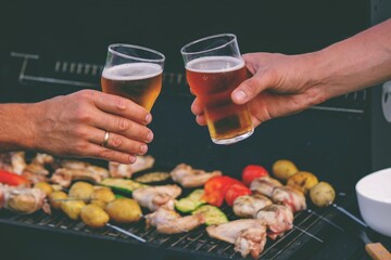 two glasses of beer against the background of a barbecue. recreation. nature.