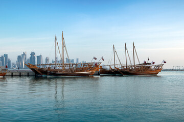 Dhows moored off Museum Park in central Doha, Qatar, Arabia, with some of the buildings from the...