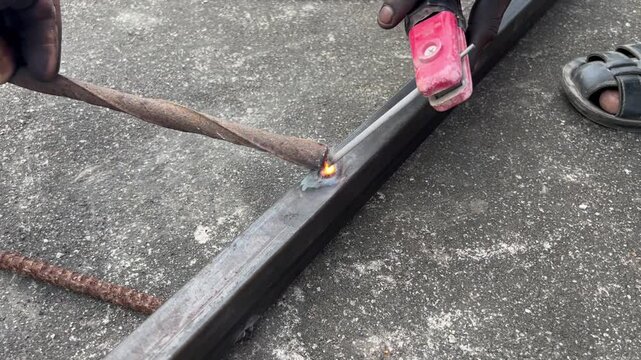 Welder working at the industry. Welder welding a metal part in the industry or factory. Construction worker working at the construction area. Welding metal with a welding machine.
