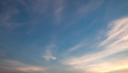 Fototapeta premium the sky is clear with fiuffy white clouds and beautiful orange light.