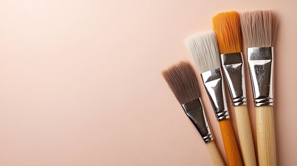 Fototapeta premium Four Paintbrushes On Pale Pink Background