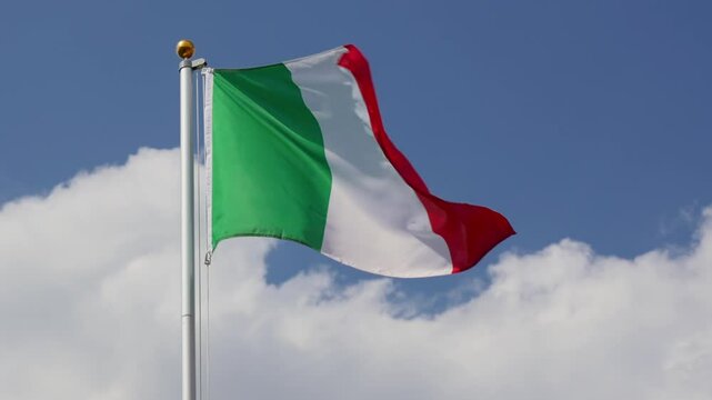Waving Italy flag flying on a flagpole, light wind, slow motion, close up, low angle