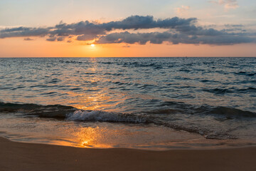 Obraz premium Sunset over the sea. Stunning seascape. Colorful Orange Sunset Light Over Sea Horizon. Scenic View