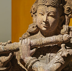Close-up view on Statue Of Krishna Playing Flute. Krishnas Love Songs Are Both Shravya And Drishya...
