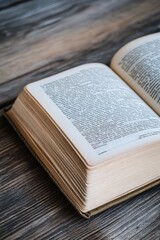 Fototapeta premium An open book sits on a wooden table, perfect for reading or studying