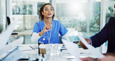 Doctors, nurses and paperwork in meeting for hospital management, funding or planning in busy...
