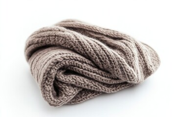 A close-up of a knitted scarf laid out on a white surface, perfect for use in fashion or textile related contexts