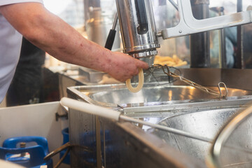 Delicious fritters being prepared in a vibrant kitchen setting filled with sizzling sounds and warm aromas