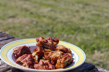 
a plate with a delicious meat dish served on a wooden surface.