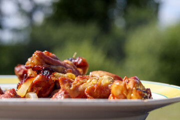 a plate with a delicious meat dish served on a wooden surface.