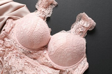 Flat lay with women romantic underwear on black background, top view